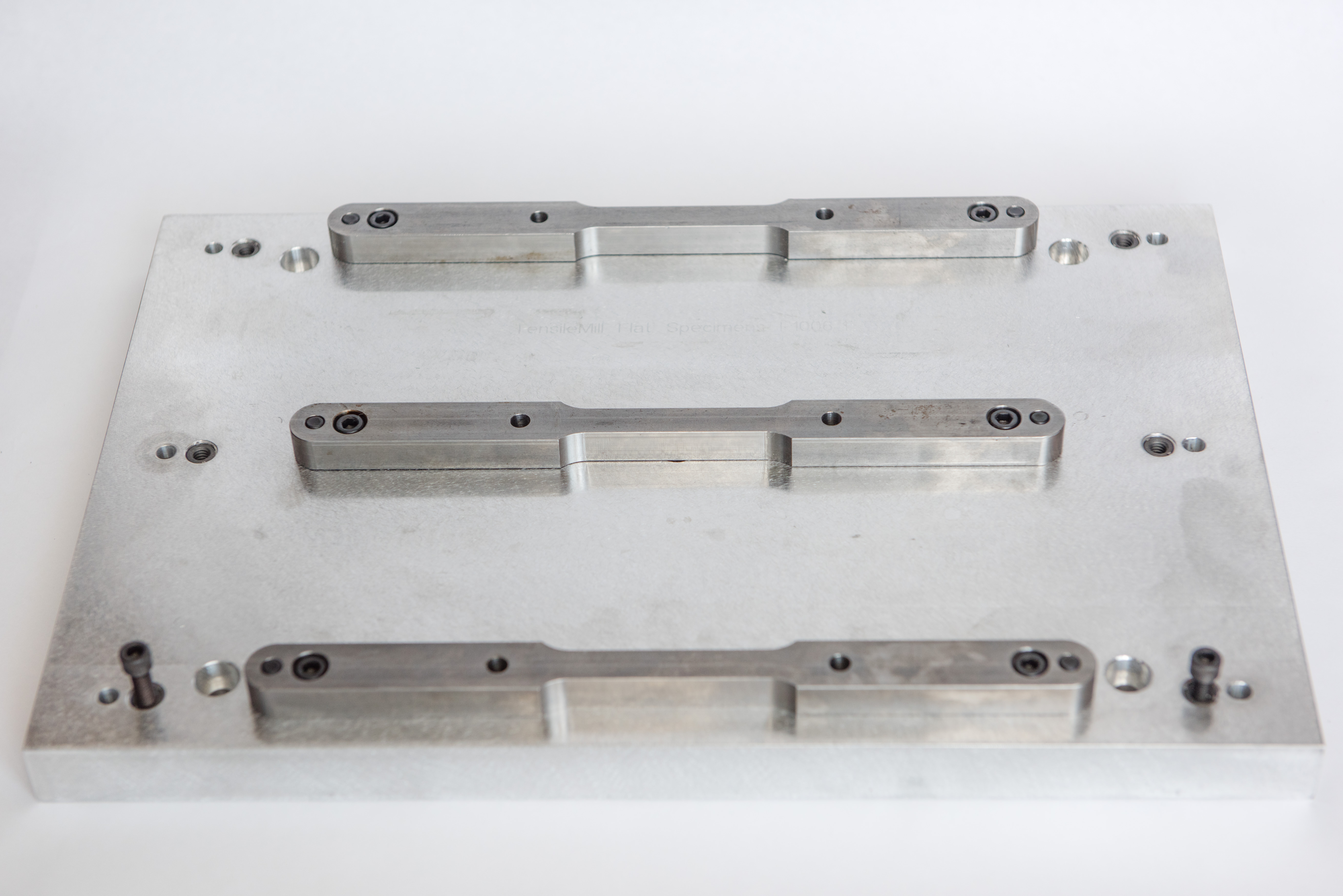 Custom clamping fixture for flat tensile sample preparation system